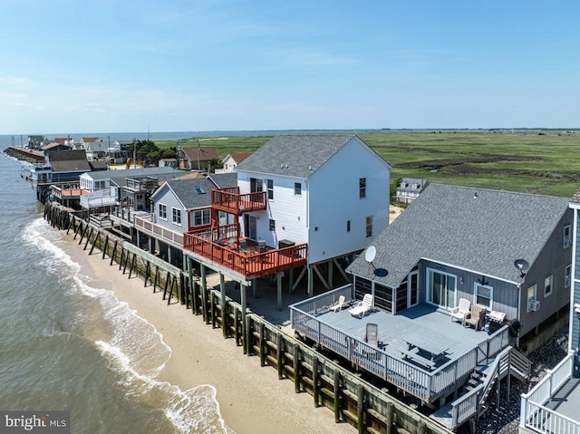 drone / aerial view with a water view and a view of the beach