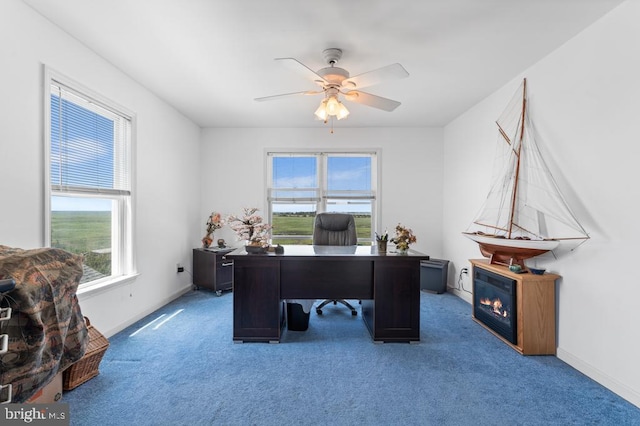 carpeted home office with ceiling fan