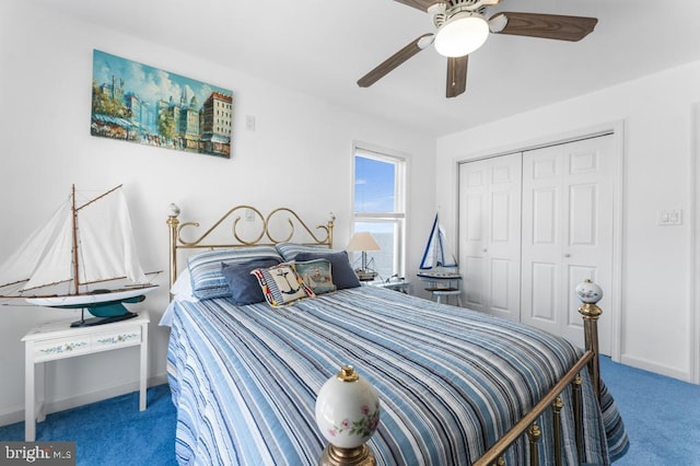 carpeted bedroom featuring ceiling fan and a closet