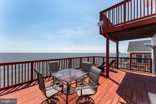 wooden terrace featuring a water view