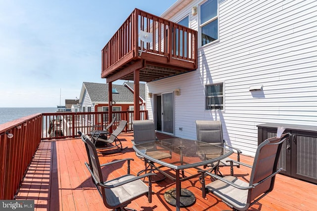 wooden deck featuring a water view and cooling unit