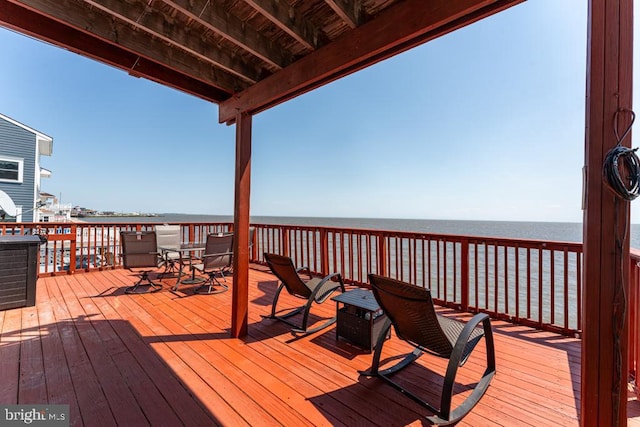 wooden deck with a water view