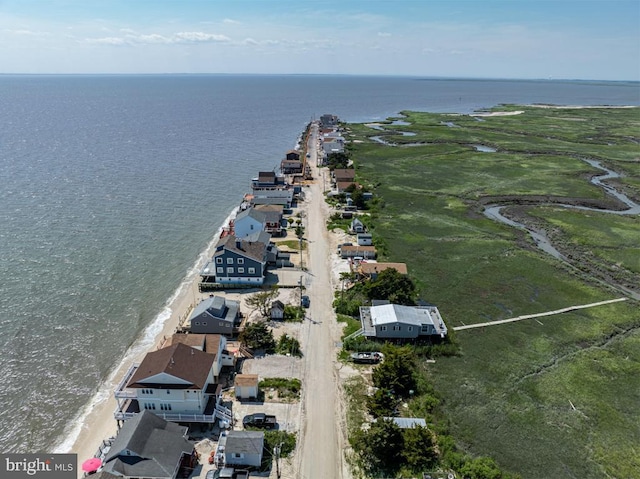 bird's eye view with a water view and a beach view