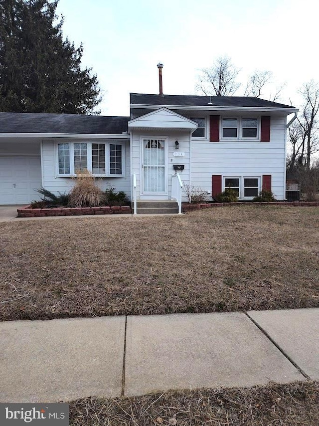 view of front of house featuring a garage and a front lawn