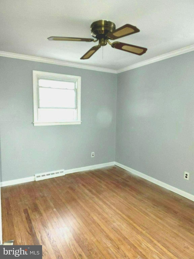 unfurnished room featuring ornamental molding and wood-type flooring