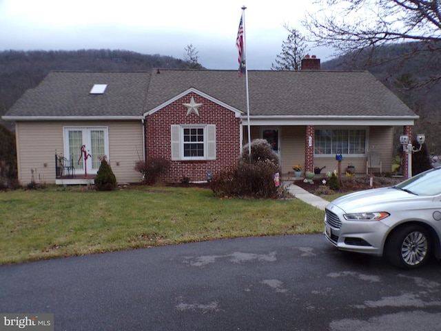 ranch-style house featuring a front lawn