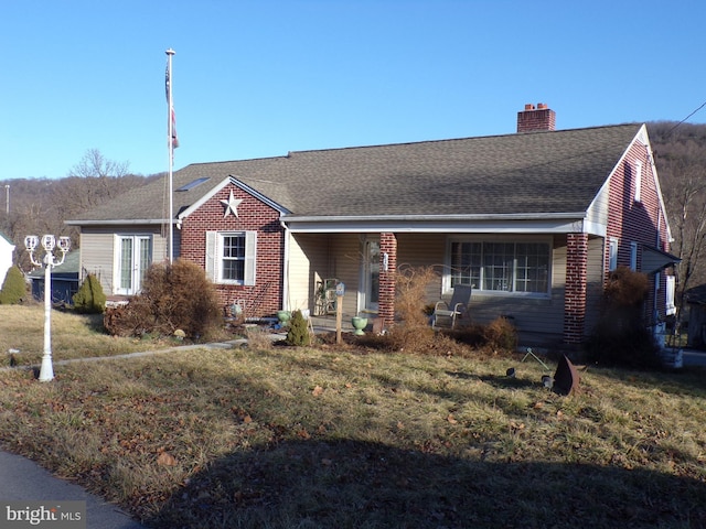 single story home featuring covered porch and a front lawn