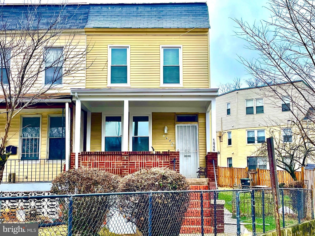 townhome / multi-family property with covered porch