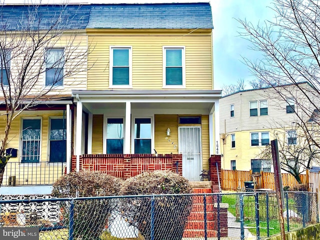 townhome / multi-family property with covered porch