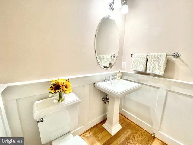 bathroom with sink, hardwood / wood-style floors, and toilet