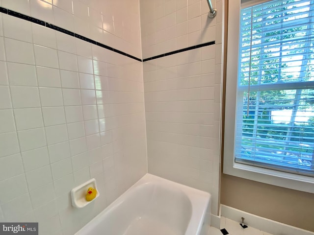 bathroom featuring tiled shower / bath combo and a wealth of natural light