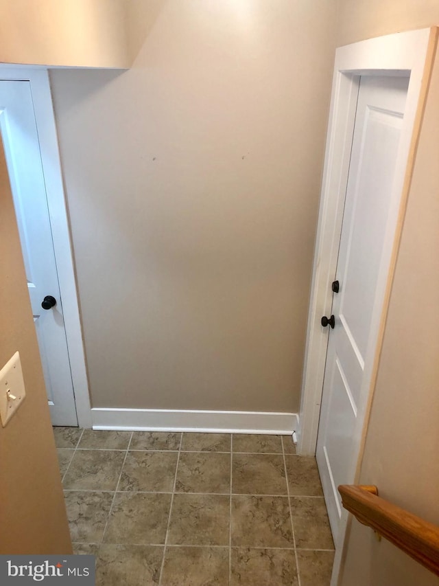 laundry room featuring dark tile patterned flooring