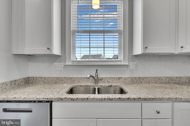 kitchen featuring white cabinetry, sink, light stone countertops, and dishwasher