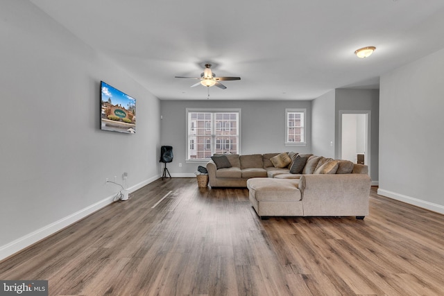 living room with hardwood / wood-style floors and ceiling fan