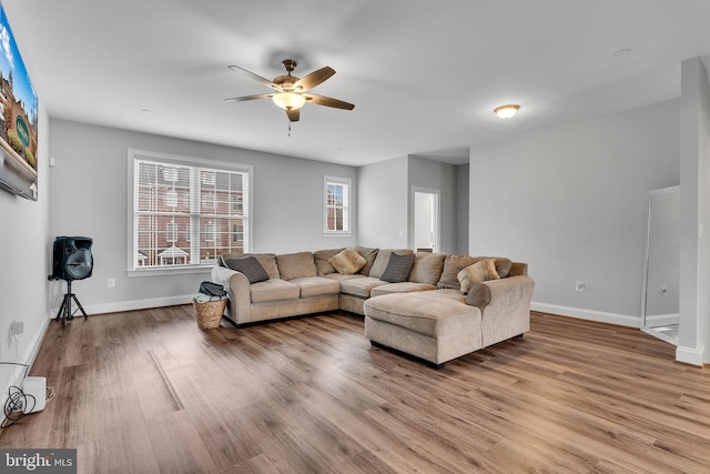 living room featuring ceiling fan and light hardwood / wood-style flooring