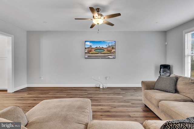 living room with hardwood / wood-style flooring and ceiling fan