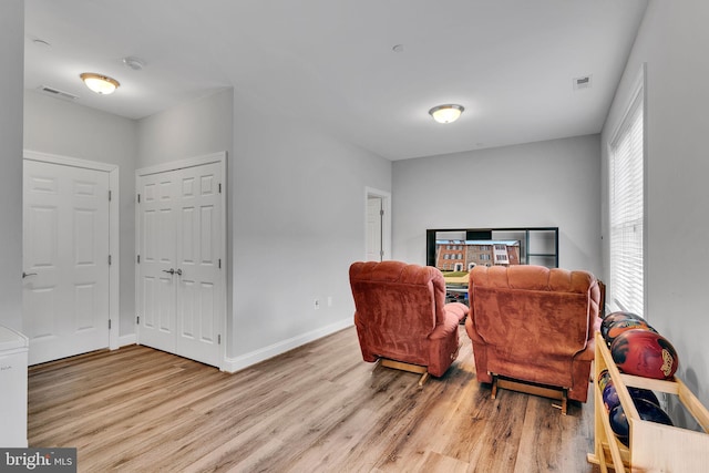 sitting room featuring light hardwood / wood-style floors