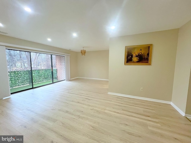 spare room with light hardwood / wood-style flooring