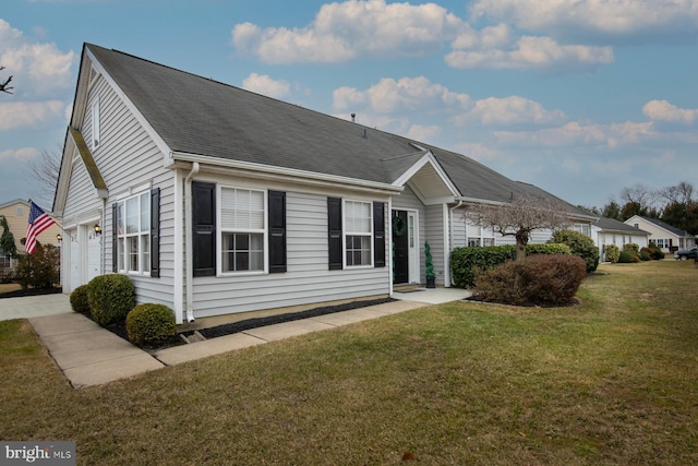 exterior space with a garage and a front lawn