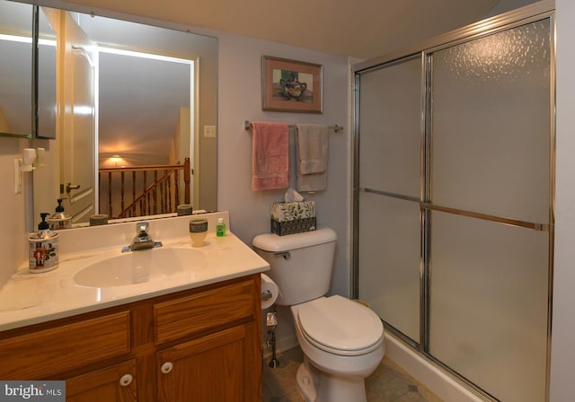 bathroom featuring walk in shower, tile patterned floors, vanity, and toilet