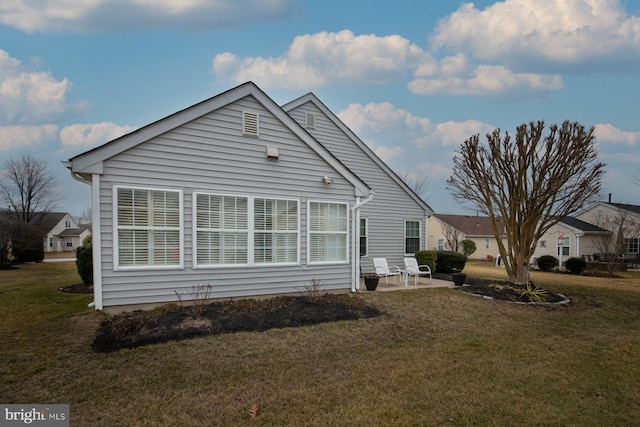 view of property exterior with a yard and a patio