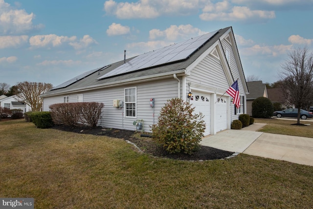 view of side of property featuring a garage, a lawn, and solar panels