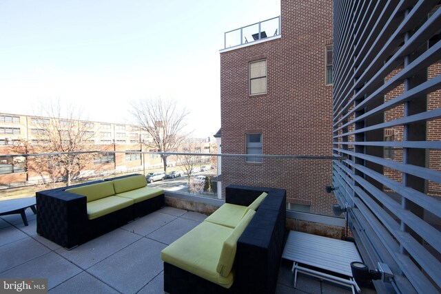 view of patio featuring an outdoor living space and a balcony