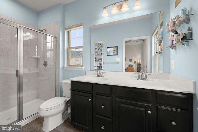 bathroom with double vanity, a stall shower, and a sink