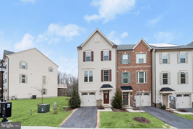 view of property with driveway, central air condition unit, an attached garage, and a front lawn