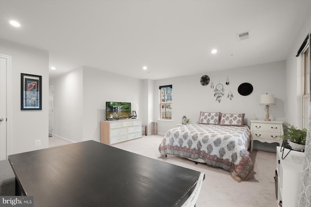 bedroom with light carpet, visible vents, and recessed lighting