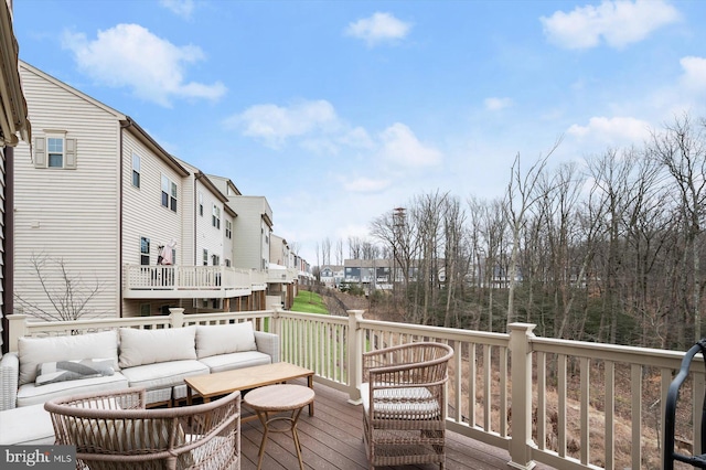 wooden terrace featuring outdoor lounge area and a residential view