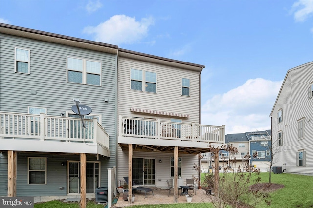 back of house with a patio, a lawn, and central air condition unit