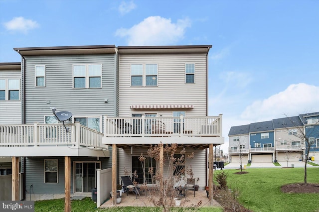 rear view of house with a patio area, a deck, and a yard