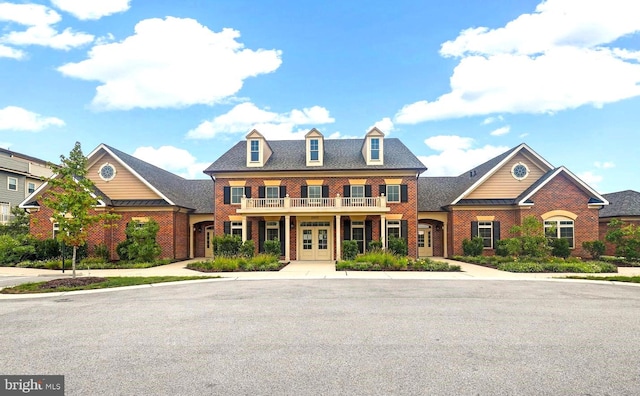 colonial inspired home with french doors and brick siding