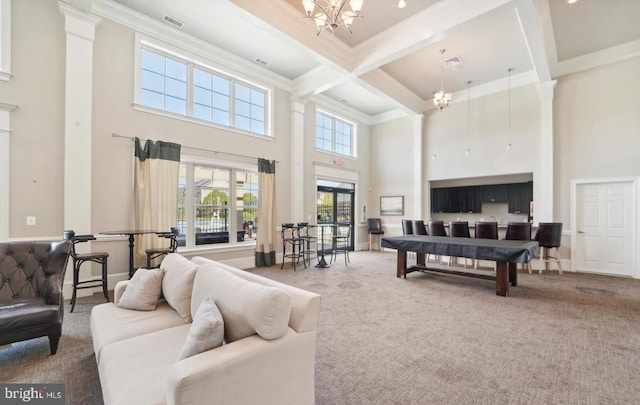 carpeted living room featuring a notable chandelier, coffered ceiling, baseboards, ornamental molding, and beam ceiling