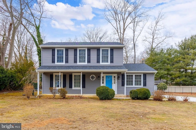 view of front of property with a porch and a front lawn