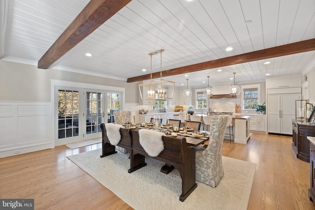 dining space featuring beamed ceiling, crown molding, light hardwood / wood-style floors, and french doors