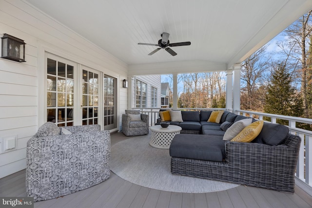 wooden terrace featuring outdoor lounge area, french doors, and ceiling fan