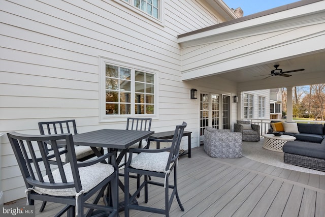 wooden terrace featuring ceiling fan and an outdoor hangout area