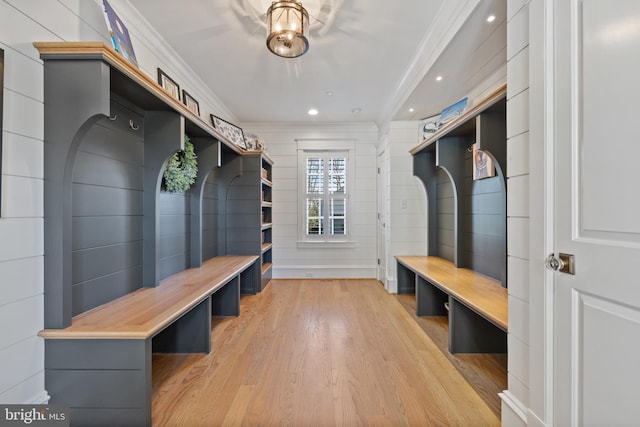 mudroom with ornamental molding and light hardwood / wood-style floors