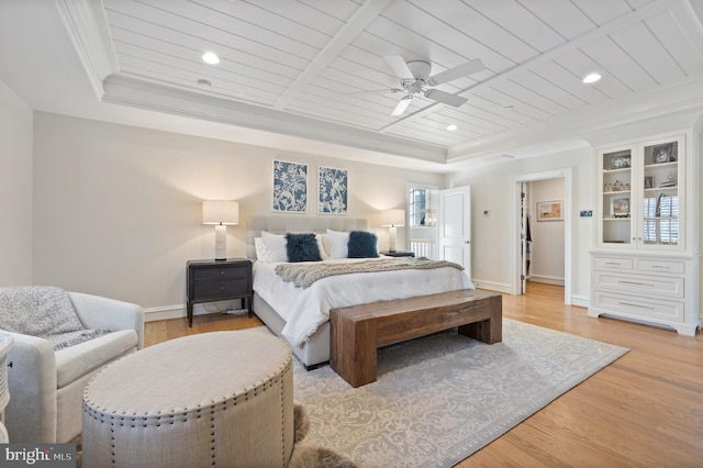 bedroom with ceiling fan, wood ceiling, a raised ceiling, crown molding, and light hardwood / wood-style flooring