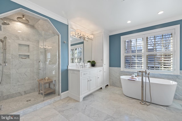 bathroom with vanity, ornamental molding, and independent shower and bath