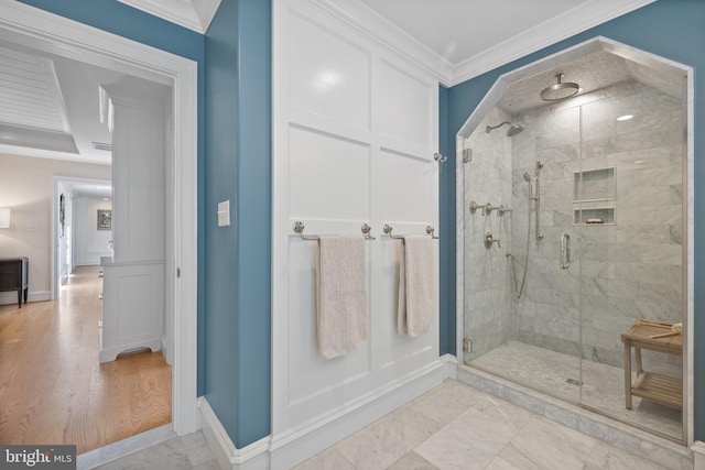 bathroom featuring ornamental molding and walk in shower