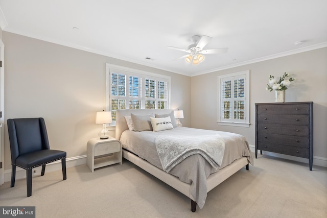 bedroom featuring crown molding, light colored carpet, and ceiling fan