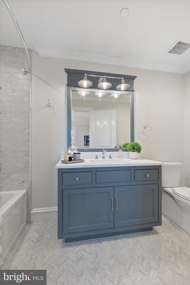 full bathroom with vanity, toilet, and tiled shower / bath