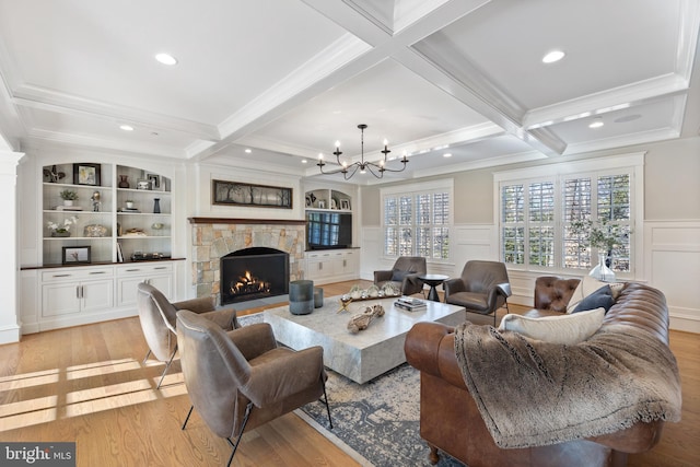 living room featuring coffered ceiling, beam ceiling, a fireplace, and light wood-type flooring