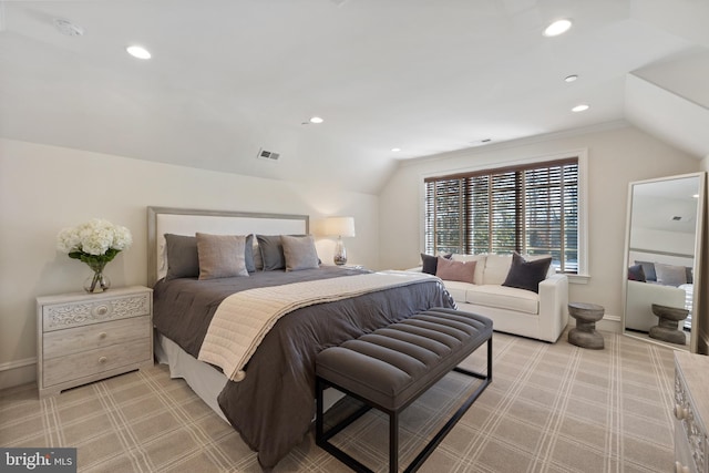 bedroom with vaulted ceiling and light colored carpet