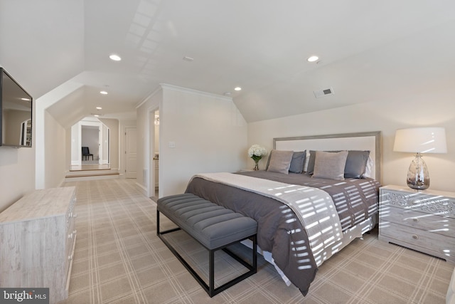 bedroom featuring vaulted ceiling and light colored carpet