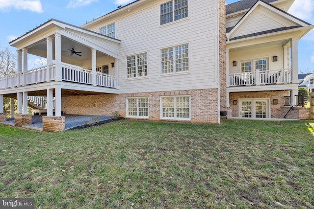 rear view of house featuring a yard, a patio area, french doors, and ceiling fan