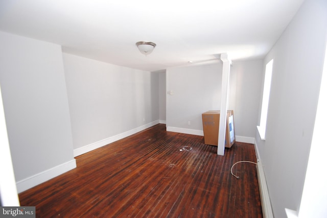 spare room featuring dark wood-type flooring